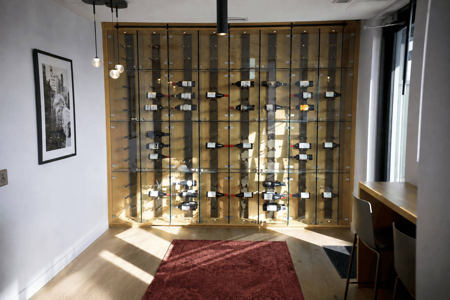 Built-in wood and glass wine display cabinetry with backlit glass shelving